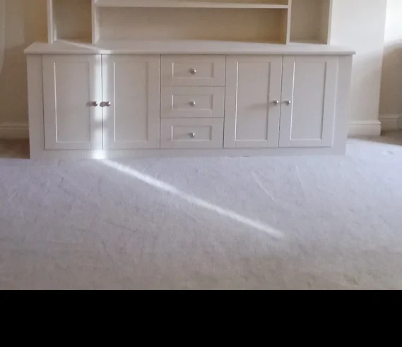 Custom wooden shelving built by Champion Carpentry.